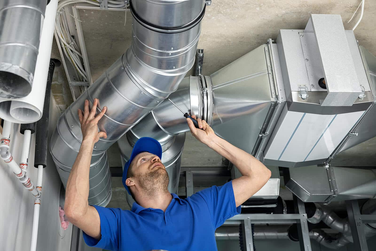 HVAC technician inspecting and repairing air ducts in Long Beach