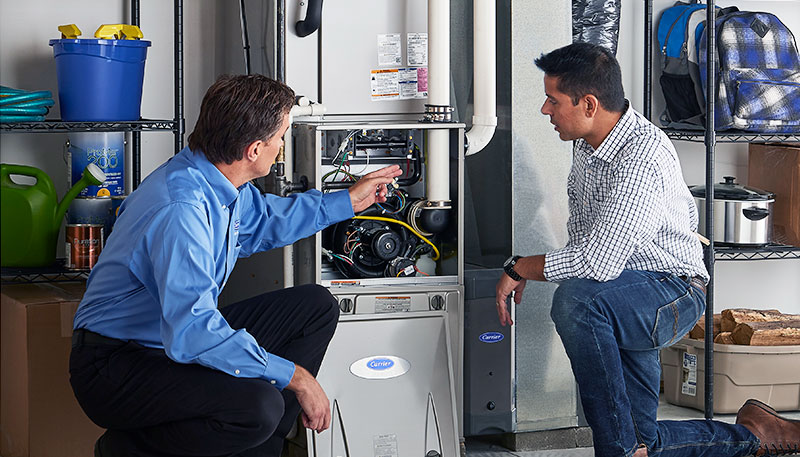 Technician evaluating a furnace for repair or replacement in Long Beach