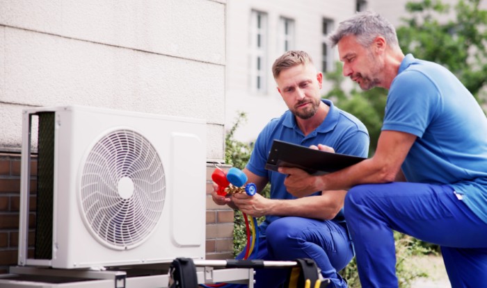 HVAC technicians installing an outdoor air conditioning unit in Long Beach