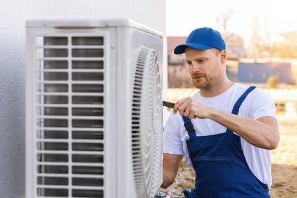 HVAC technician servicing an outdoor air conditioner in Long Beach