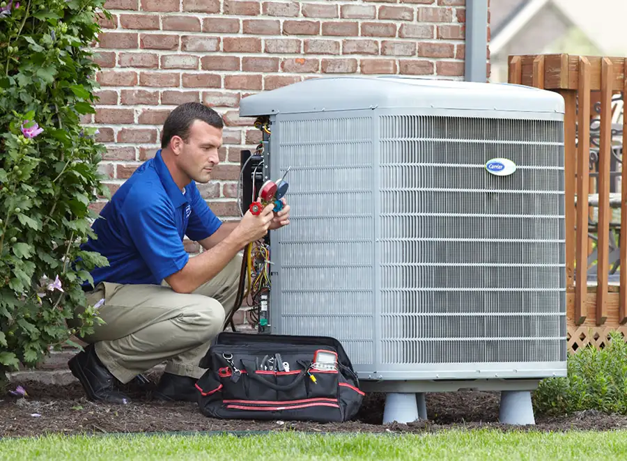 HVAC technician inspecting an outdoor AC unit in Long Beach