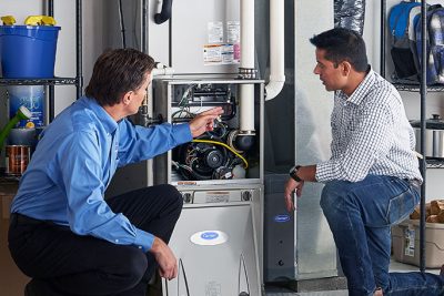 Technician evaluating a furnace for repair or replacement in Long Beach