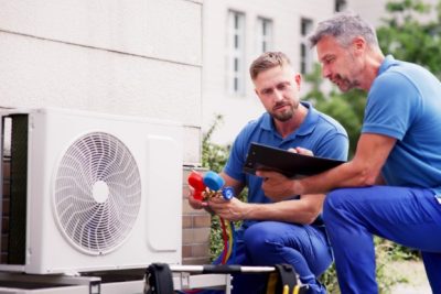 HVAC technicians installing an outdoor air conditioning unit in Long Beach